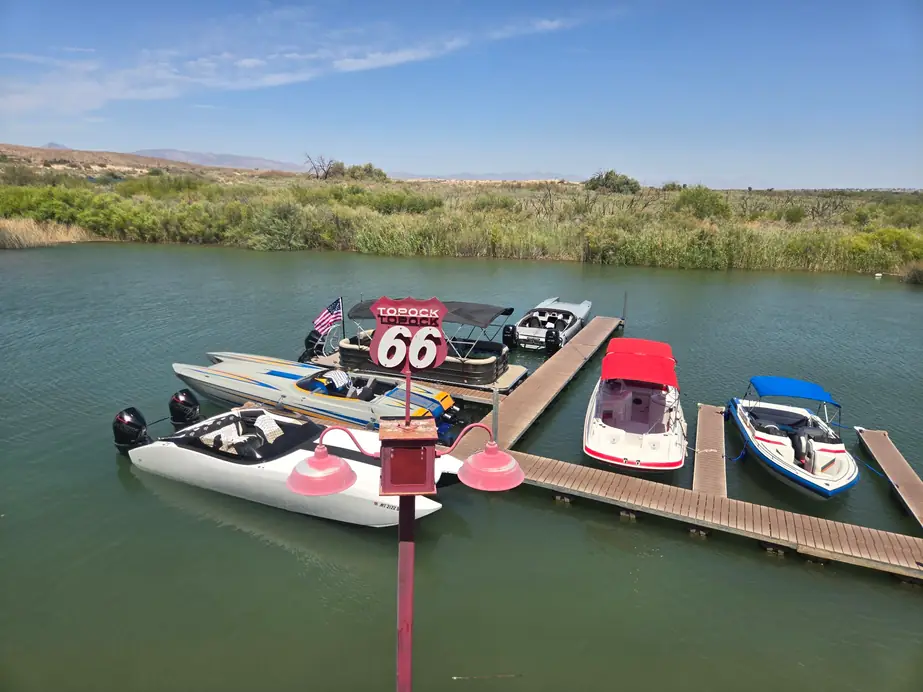 Boats tied up at the Topock66 docks under the red TOPOCK 66 sign