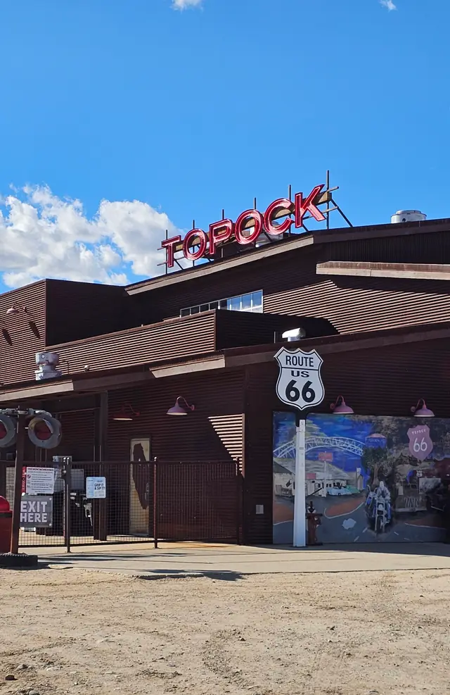 The Topock66 building in rust corrugated steel with the TOPOCK neon roof sign and the US 66 shield