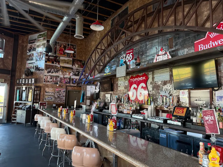 The Topock66 bar under its arched steel truss with Route 66 shields over the back bar